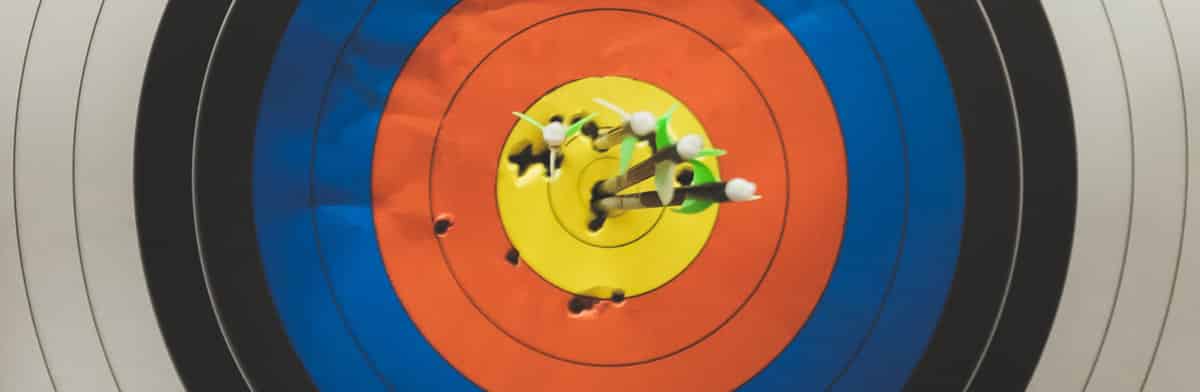 Arrows clustered in the bullseye of an archery target